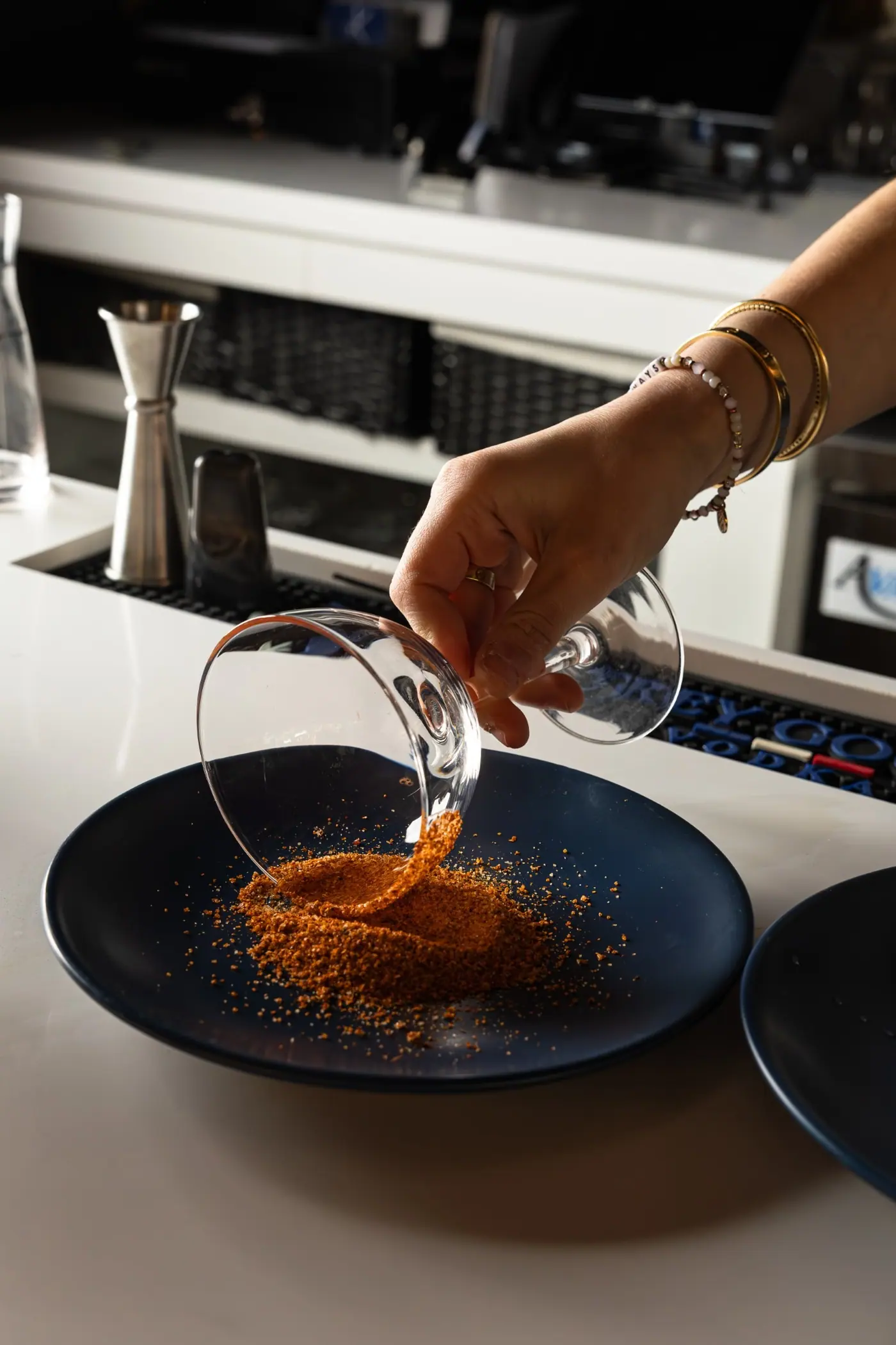 A dish being finished in the kitchen